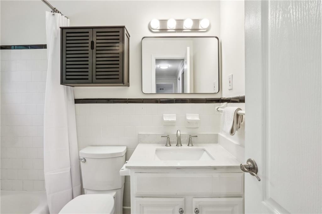 311 Peachtree Hills Avenue Northeast, Unit 13B Atlanta, GA 30305 - Photo 25 of 30 a bathroom with a sink toilet and mirror