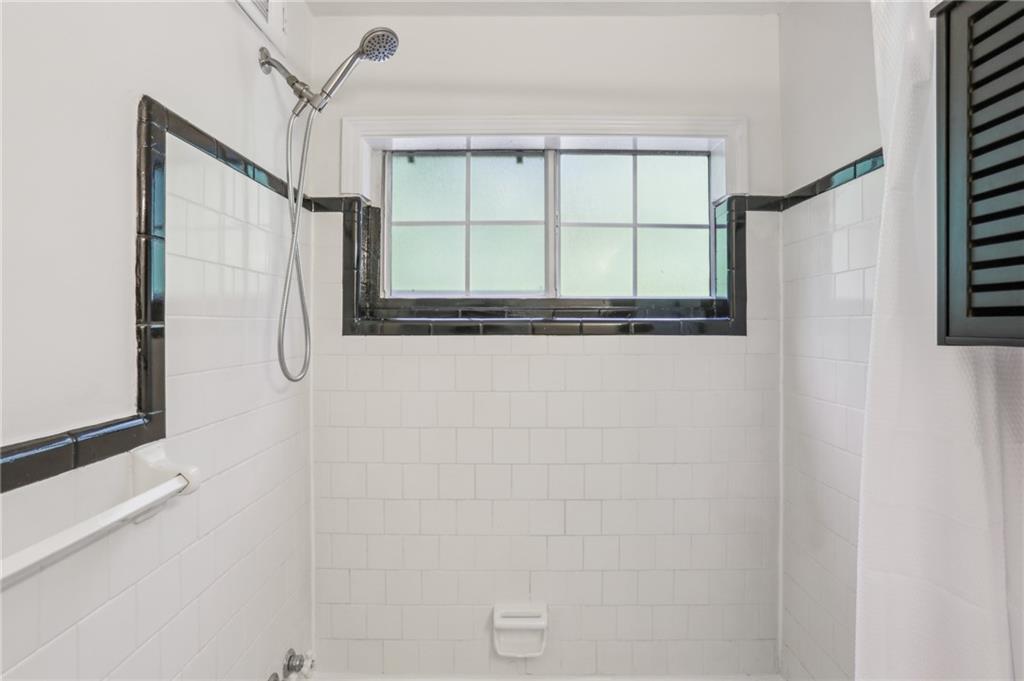 311 Peachtree Hills Avenue Northeast, Unit 13B Atlanta, GA 30305 - Photo 26 of 30 a bathroom with a window and a shower