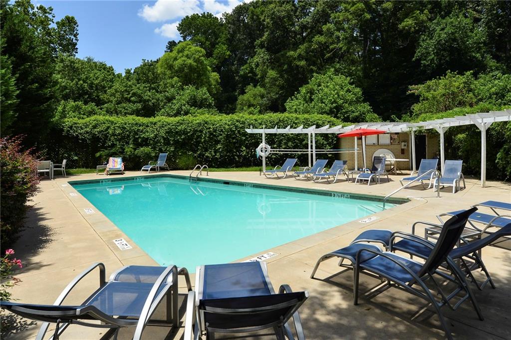 311 Peachtree Hills Avenue Northeast, Unit 13B Atlanta, GA 30305 - Photo 27 of 30 a view of a swimming pool with chairs