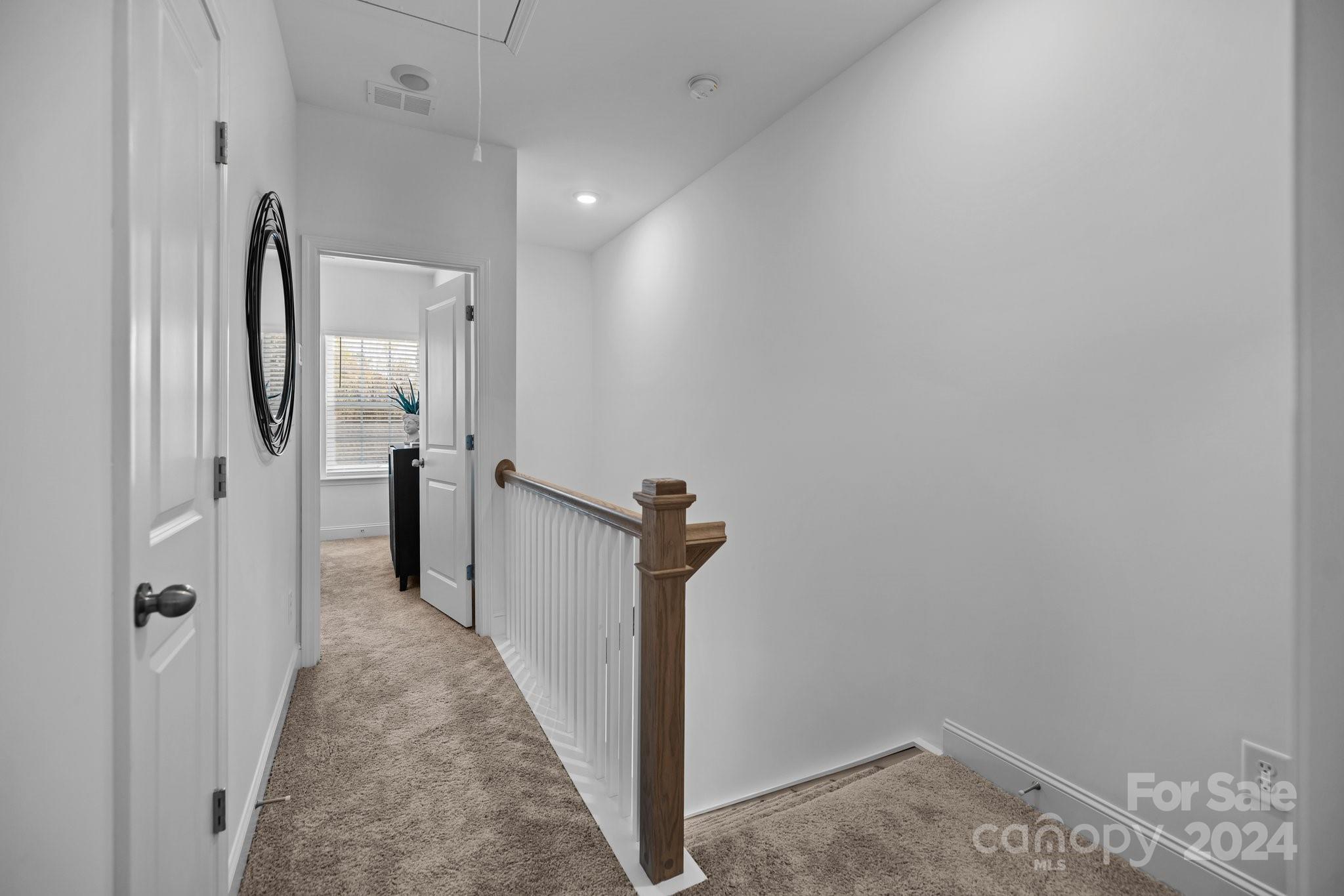 3018 Butler Hl Drive Matthews, NC 28105 - Photo 13 of 20 a view of a hallway with a white refrigerator freezer and a dishwasher