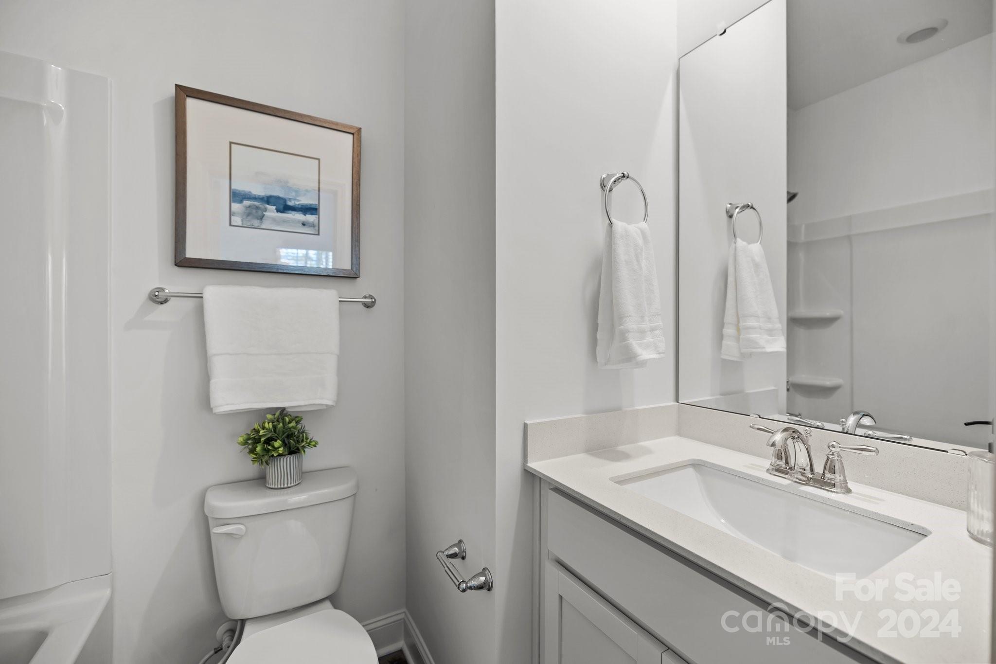 3018 Butler Hl Drive Matthews, NC 28105 - Photo 14 of 20 a bathroom with a toilet sink and mirror
