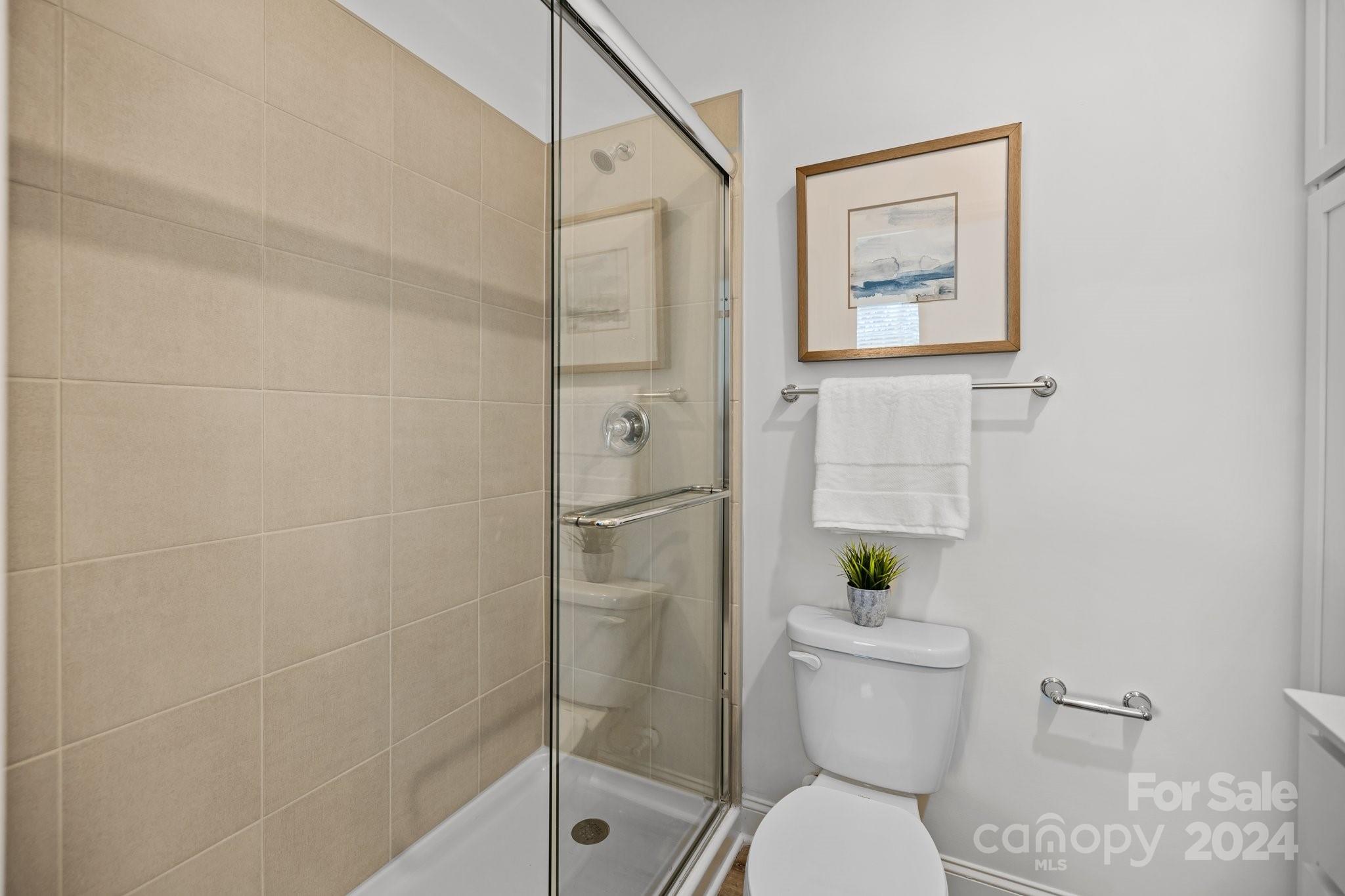 3018 Butler Hl Drive Matthews, NC 28105 - Photo 17 of 20 a white toilet sitting next to a bathroom sink