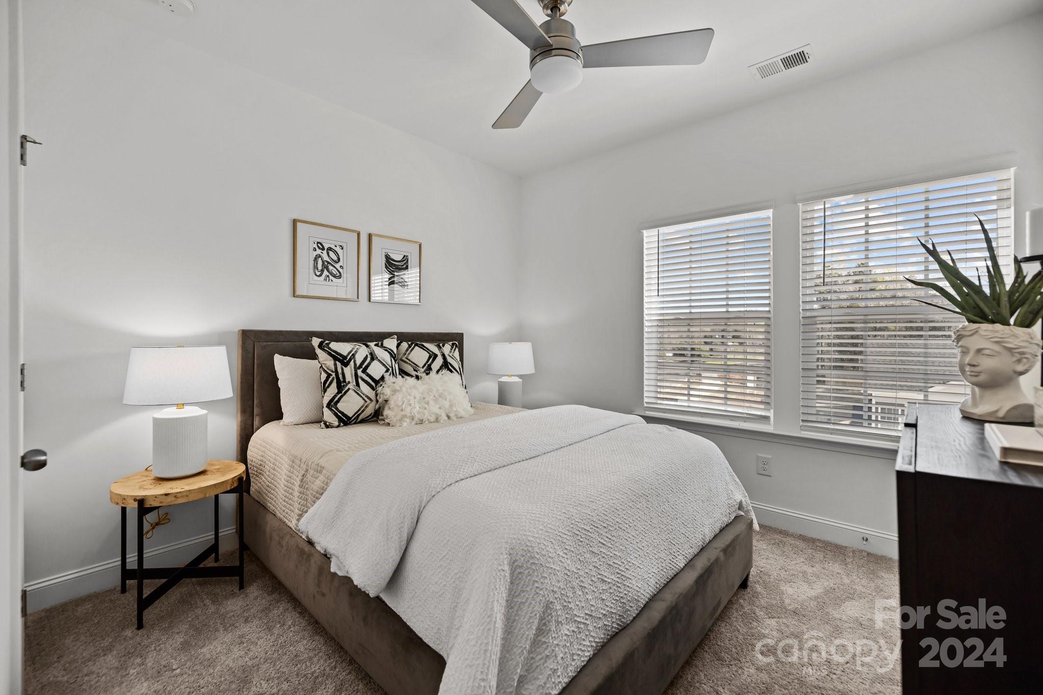 3018 Butler Hl Drive Matthews, NC 28105 - Photo 19 of 20 a bedroom with a bed painting on wall and a large window