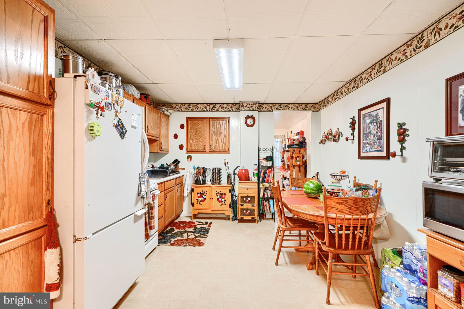 1516 Boyle Street Baltimore, MD 21230 - Photo 11 of 29 a view of a dining room with furniture a chandelier and a window