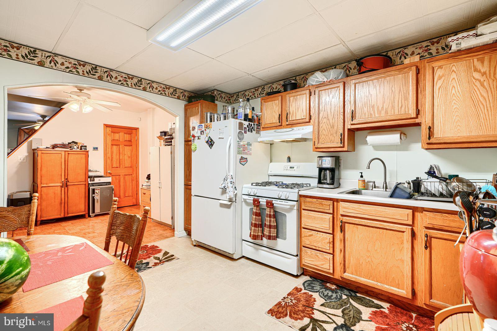1516 Boyle Street Baltimore, MD 21230 - Photo 15 of 29 a kitchen with stainless steel appliances granite countertop a sink stove and refrigerator