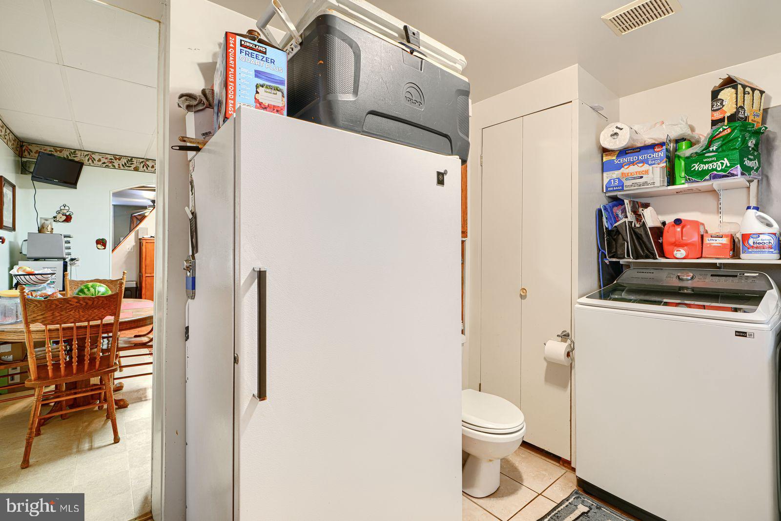 1516 Boyle Street Baltimore, MD 21230 - Photo 17 of 29 a white toilet sitting next to a bathroom sink