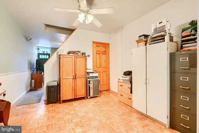 a view of a kitchen with a sink cabinet and a refrigerator