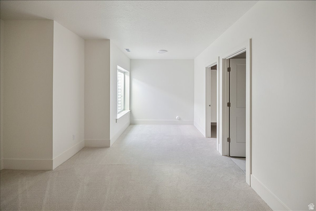 952 Mathilda Drive, Unit 156 Saratoga Springs, UT 84045 - Photo 21 of 25 Spacious room with light gray carpeting, crisp white walls, and a recessed window. Ensuite bathroom as well