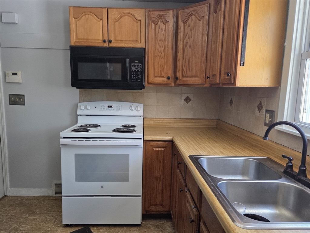 186 Bolton Street Springfield, MA 01119 - Photo 14 of 34 a kitchen with a stove microwave and sink