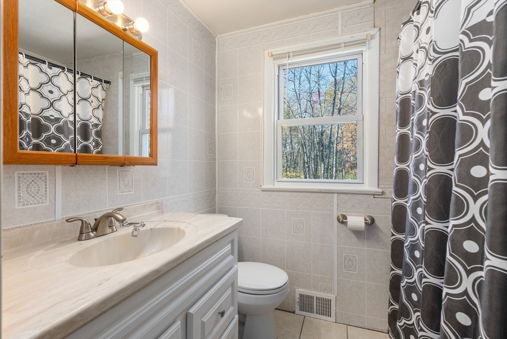 186 Bolton Street Springfield, MA 01119 - Photo 25 of 34 a bathroom with a sink and mirror with toilet