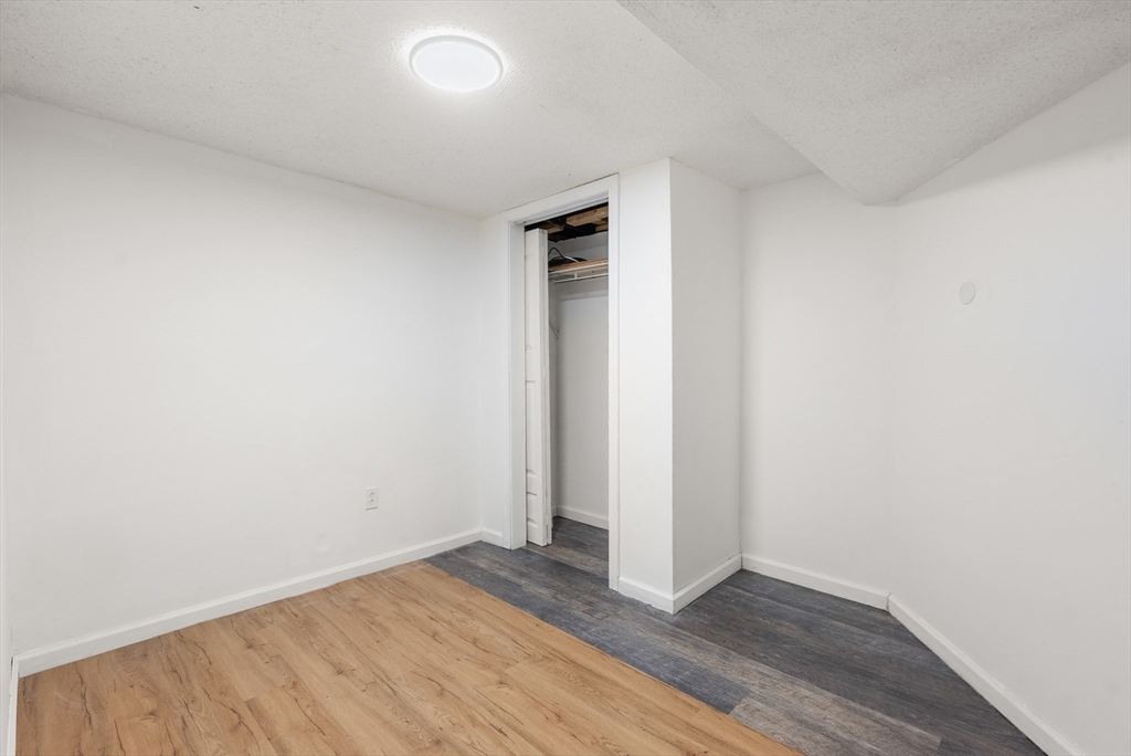 186 Bolton Street Springfield, MA 01119 - Photo 29 of 34 an empty room with wooden floor and closet