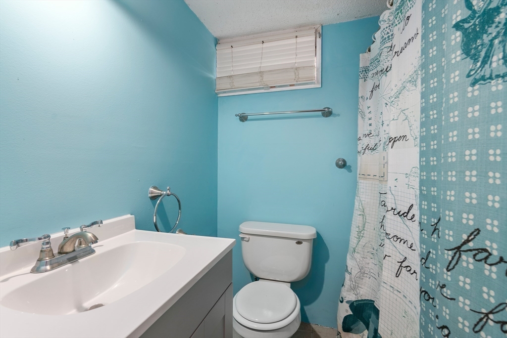 186 Bolton Street Springfield, MA 01119 - Photo 31 of 34 a bathroom with a sink a toilet and shower curtain