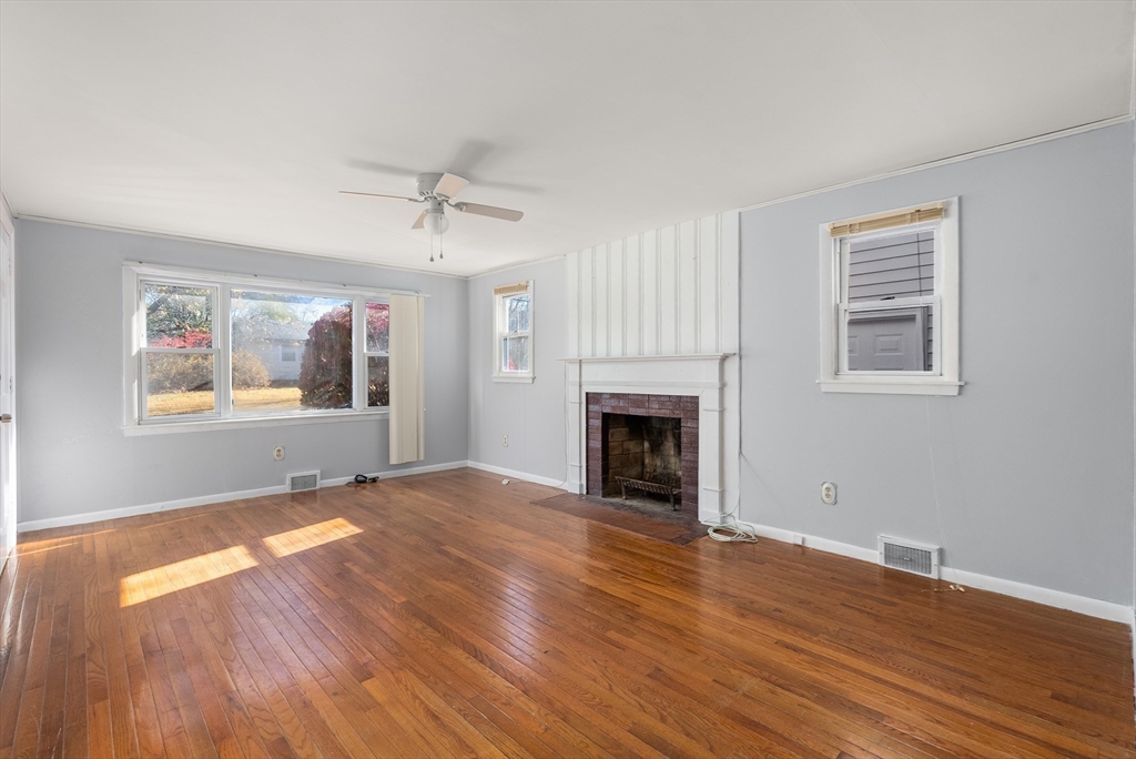 186 Bolton Street Springfield, MA 01119 - Photo 9 of 34 a view of empty room with wooden floor and fireplace