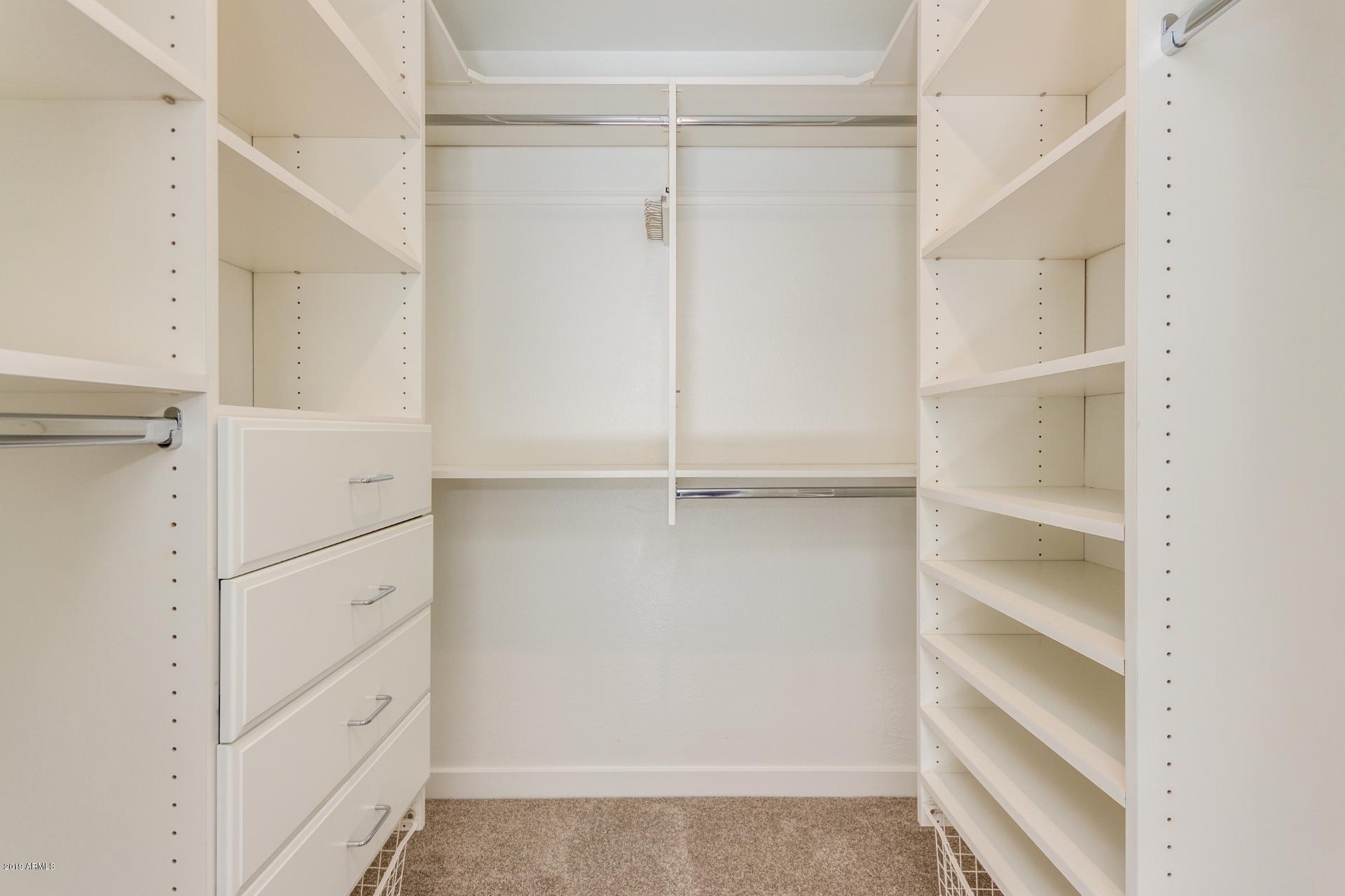 5503 South Rocky Point Road Tempe, AZ 85283 - Photo 11 of 22 a view of walk in closet with empty racks