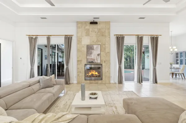 a living room with furniture and large windows