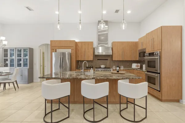 a living room with furniture chandelier and a fireplace