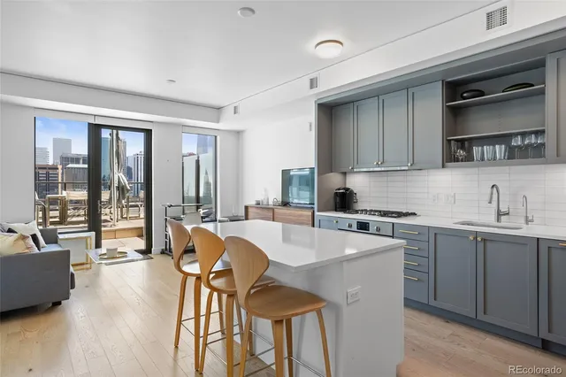 a kitchen with a table chairs sink and cabinets