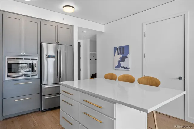 a kitchen with stainless steel appliances granite countertop a refrigerator and a sink