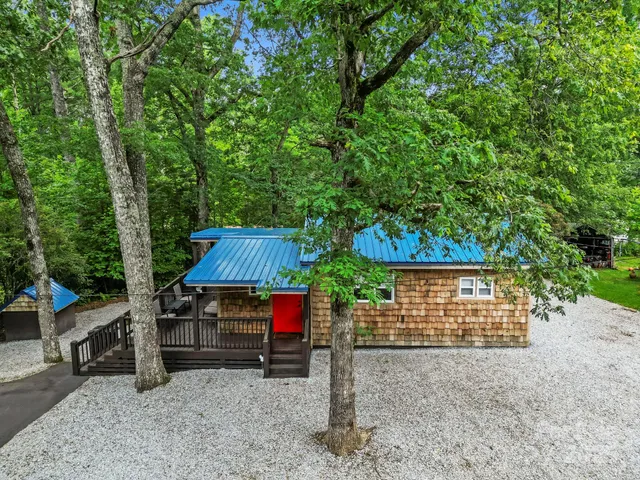 a view of backyard with deck and outdoor seating