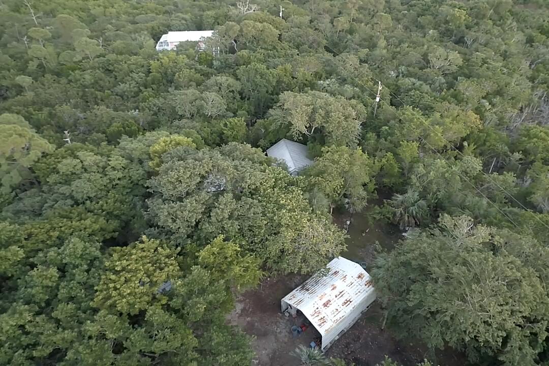 21857 Disturbed Pine Road Cudjoe, FL 33042 - Photo 1 of 31 an aerial view of a house with a yard
