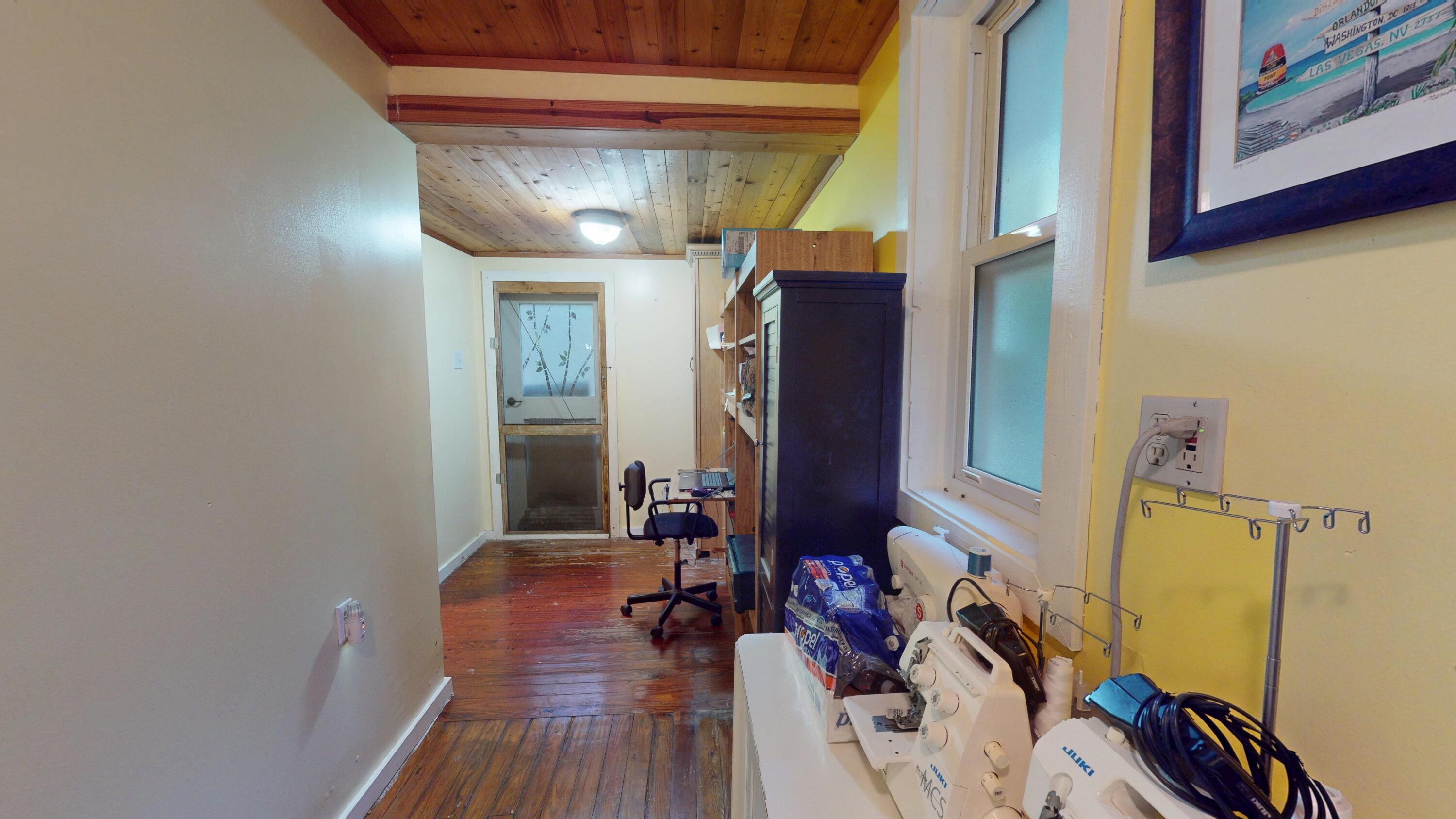 21857 Disturbed Pine Road Cudjoe, FL 33042 - Photo 11 of 31 a view of a room with wooden floor and furniture
