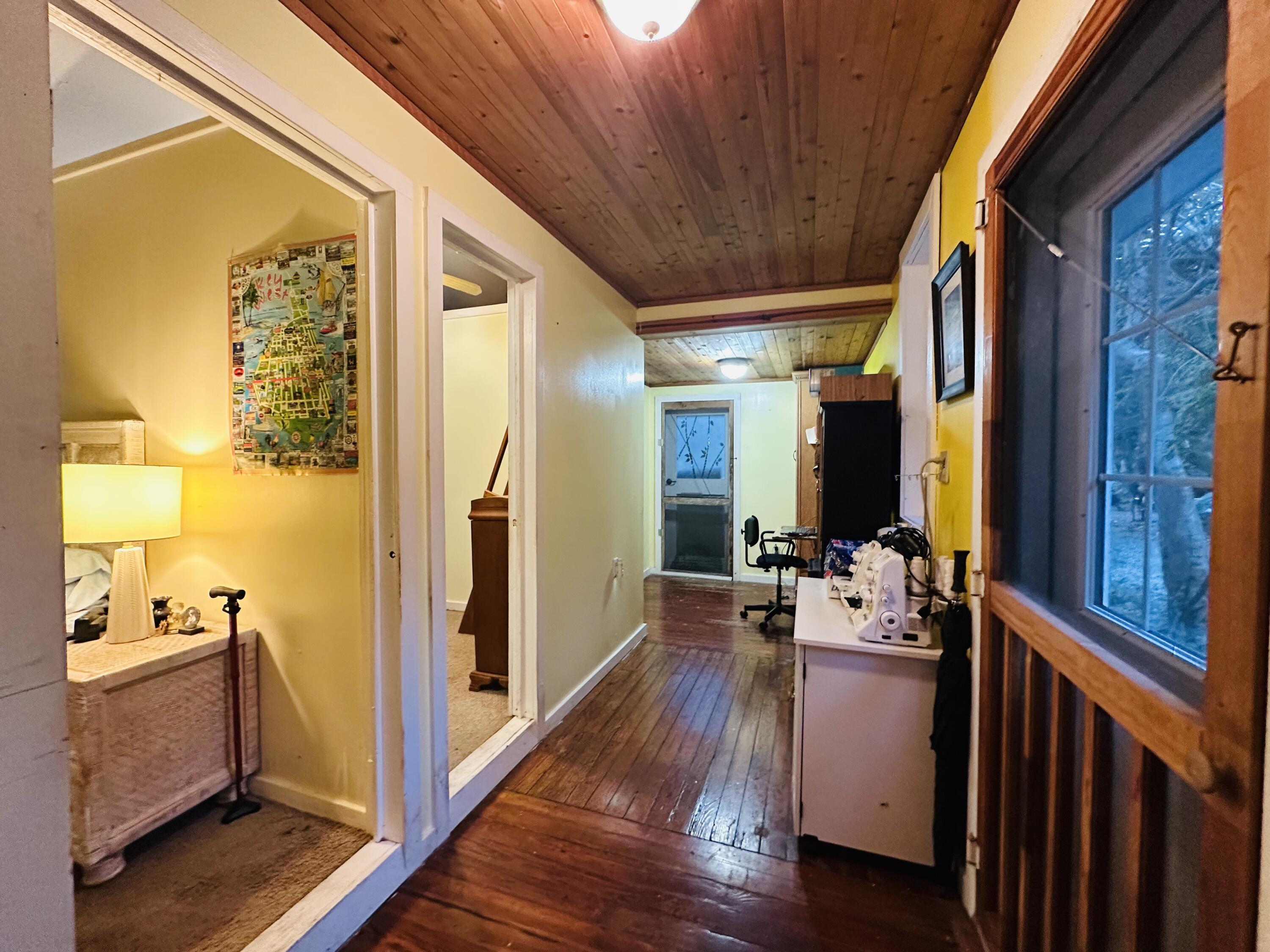 21857 Disturbed Pine Road Cudjoe, FL 33042 - Photo 12 of 31 a view of living room with furniture and wooden floor