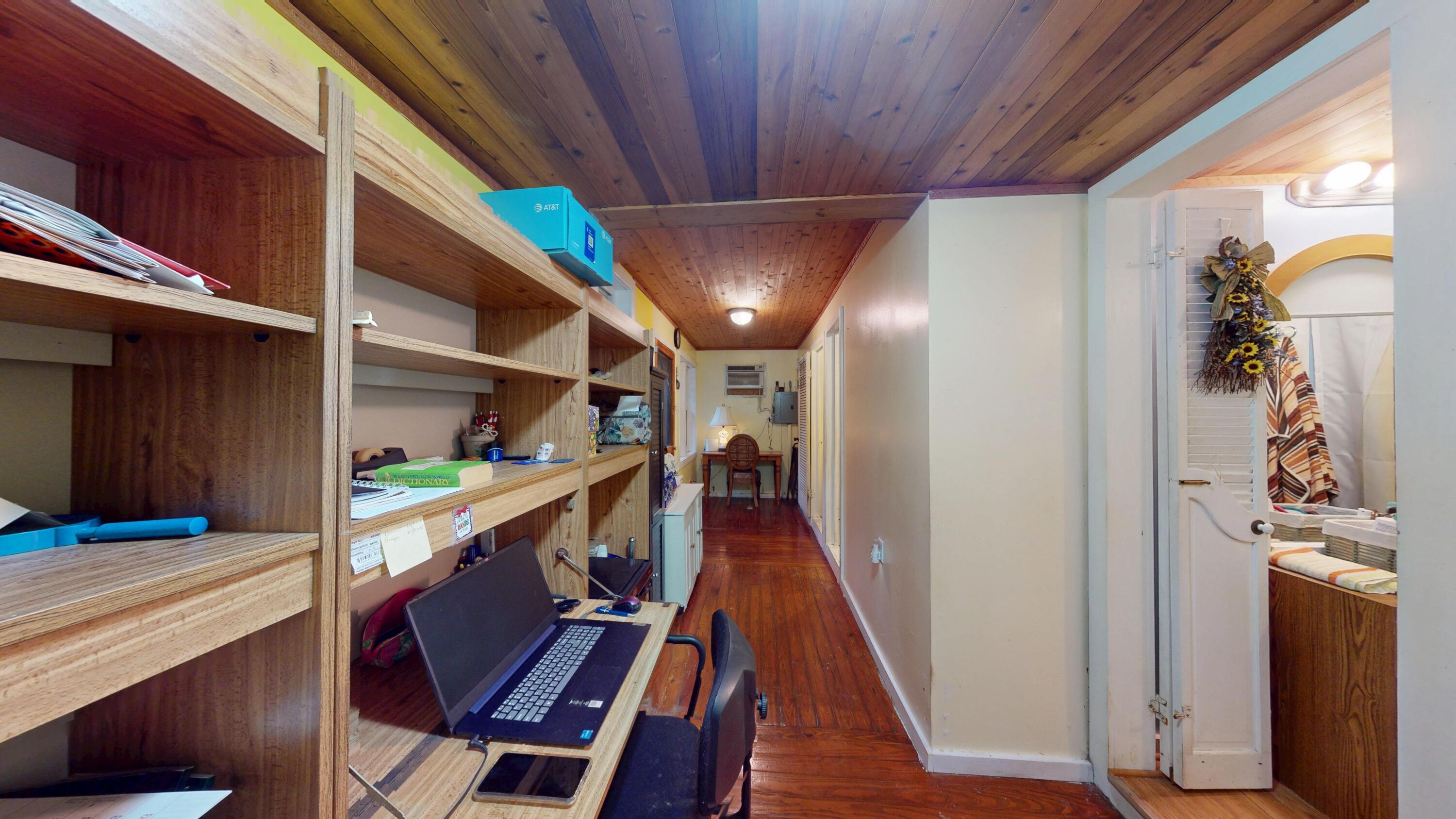 21857 Disturbed Pine Road Cudjoe, FL 33042 - Photo 13 of 31 a hallway with wooden floor stairs and furniture