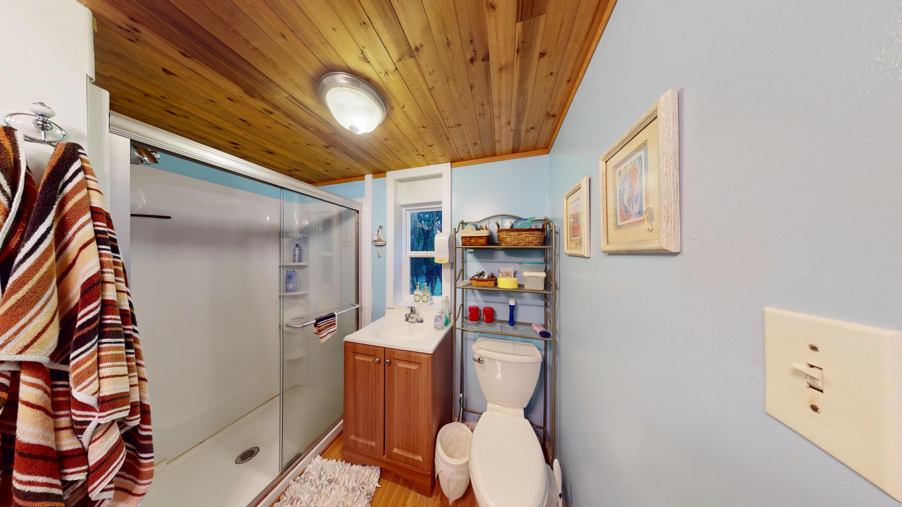 21857 Disturbed Pine Road Cudjoe, FL 33042 - Photo 19 of 31 a white toilet sitting next to a bathroom