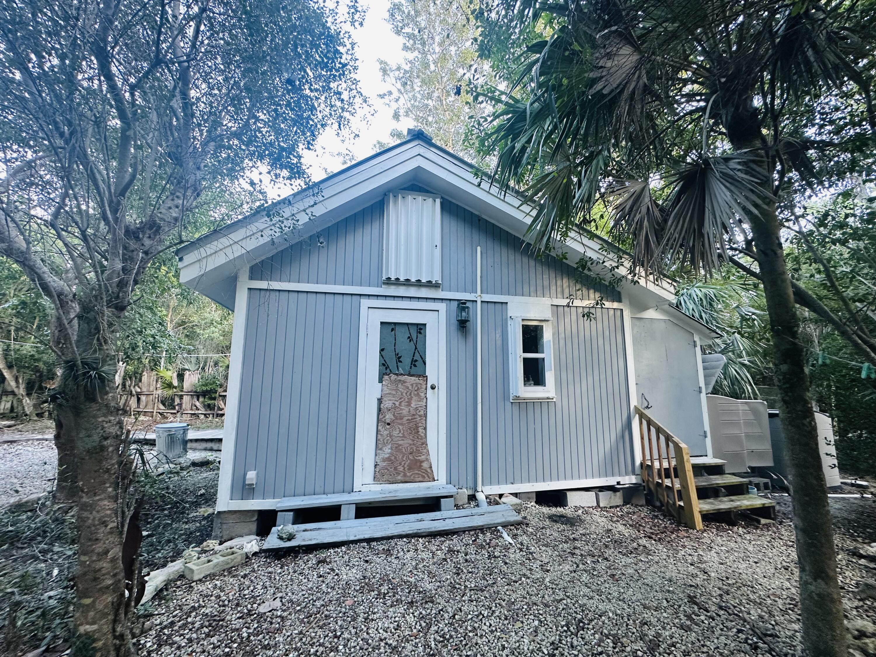 21857 Disturbed Pine Road Cudjoe, FL 33042 - Photo 20 of 31 a front view of a house with garden