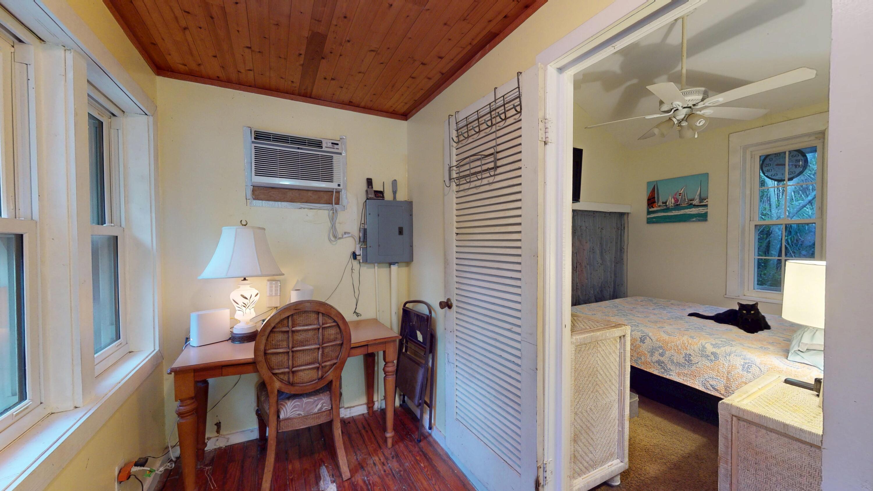 21857 Disturbed Pine Road Cudjoe, FL 33042 - Photo 8 of 31 a view of kitchen and dining room with wooden floor