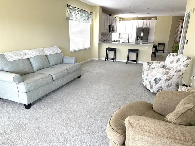 a large bedroom with a bed and a chandelier