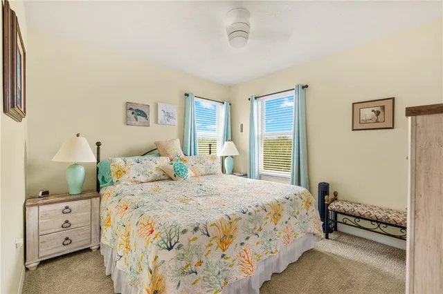 a living room with patio furniture and a floor to ceiling window