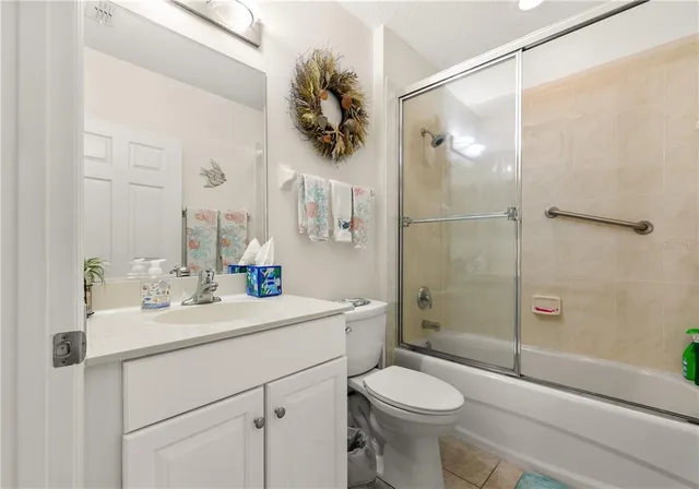 a view of a chairs and table on wooden deck with lake view