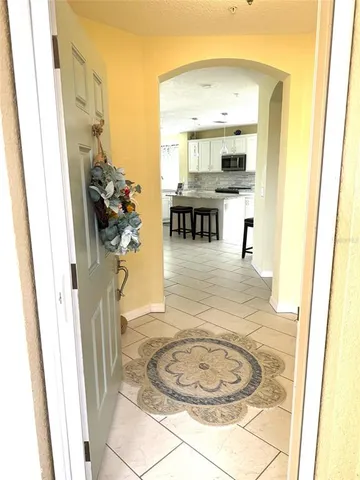 a kitchen with kitchen island granite countertop a counter top space appliances and a cabinets