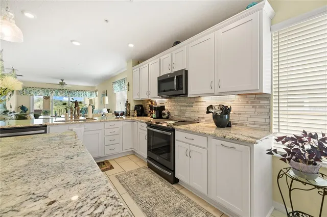 a spacious bathroom with a granite countertop sink and a mirror