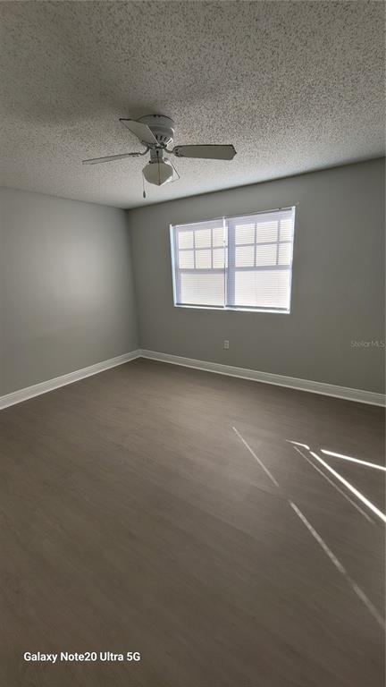 12403 Hibiscus Oak Place, Unit 101 Tampa, FL 33612 - Photo 4 of 9 an empty room with a empty space and windows