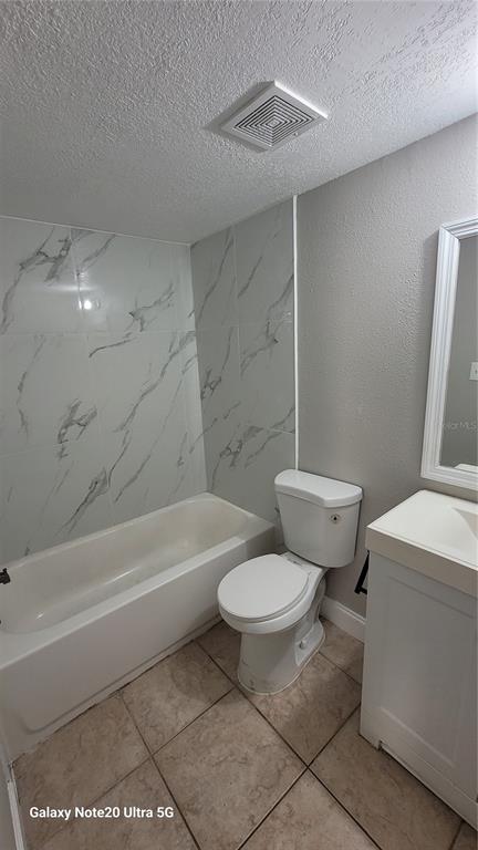 12403 Hibiscus Oak Place, Unit 101 Tampa, FL 33612 - Photo 8 of 9 a bathroom with a toilet a sink and bathtub