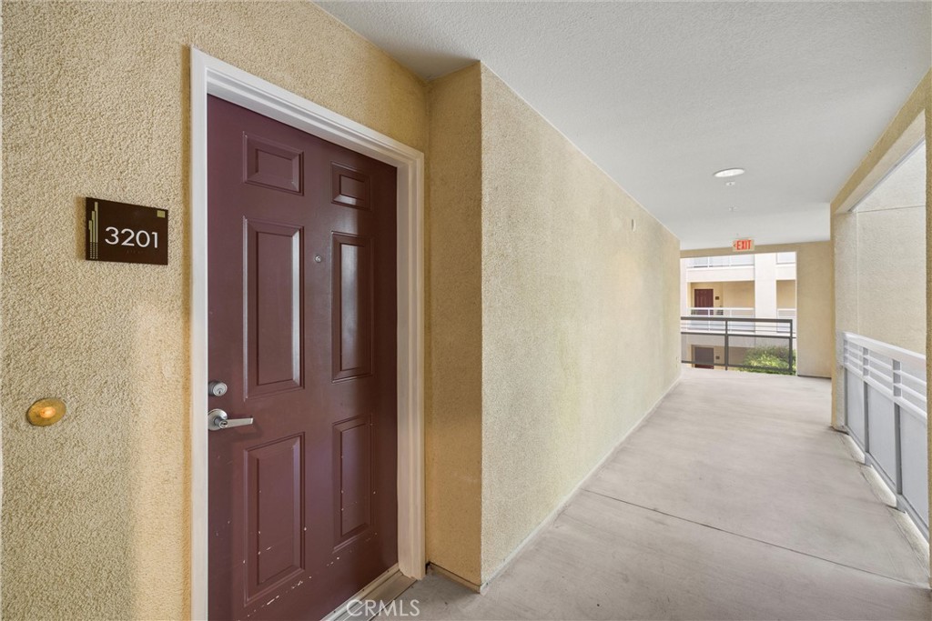 12688 Chapman Avenue, Unit 3201 Garden Grove, CA 92840 - Photo 1 of 17 a view of a hallway with wooden shelves