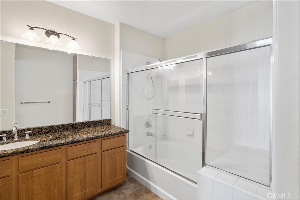 12688 Chapman Avenue, Unit 3201 Garden Grove, CA 92840 - Photo 15 of 17 a bathroom with a granite countertop sink mirror and shower