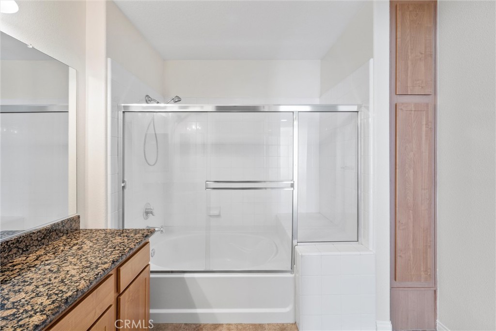 12688 Chapman Avenue, Unit 3201 Garden Grove, CA 92840 - Photo 16 of 17 a bathroom with a granite countertop sink and a mirror
