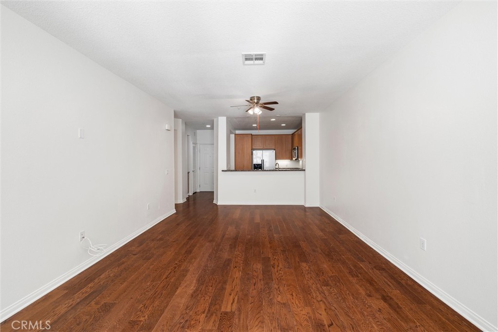 12688 Chapman Avenue, Unit 3201 Garden Grove, CA 92840 - Photo 6 of 17 a view of a room with wooden floor and kitchen view