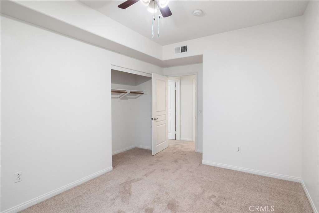 12688 Chapman Avenue, Unit 3201 Garden Grove, CA 92840 - Photo 10 of 17 a view of an empty room and chandelier fan