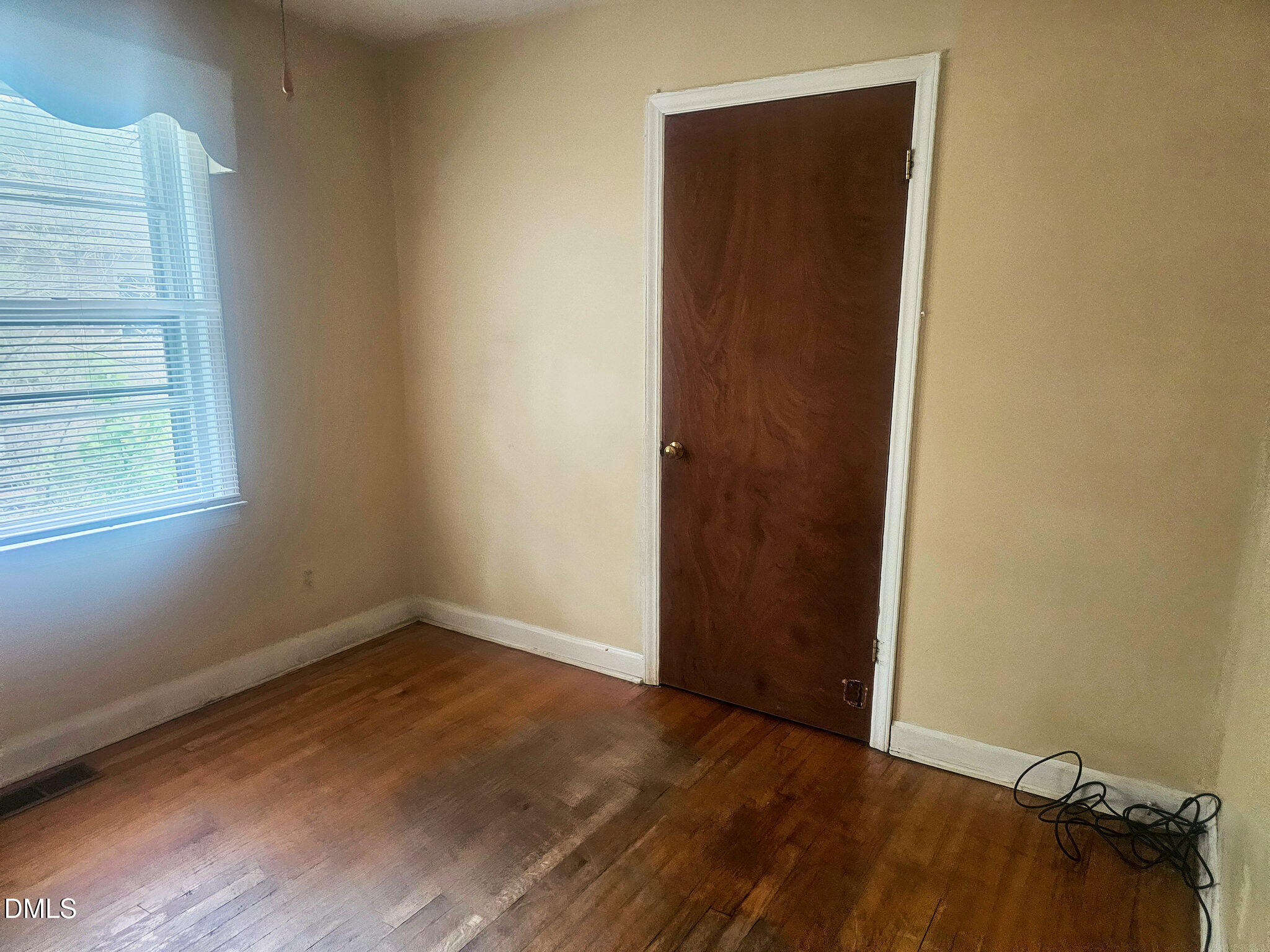 1649 Harper Street Rocky Mount, NC 27801 - Photo 14 of 34 a view of an empty room with wooden floor and a window