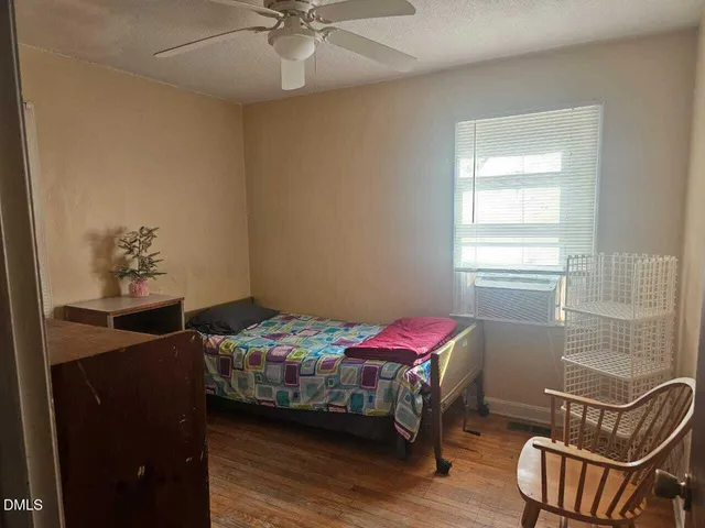 a view of room with wooden floor