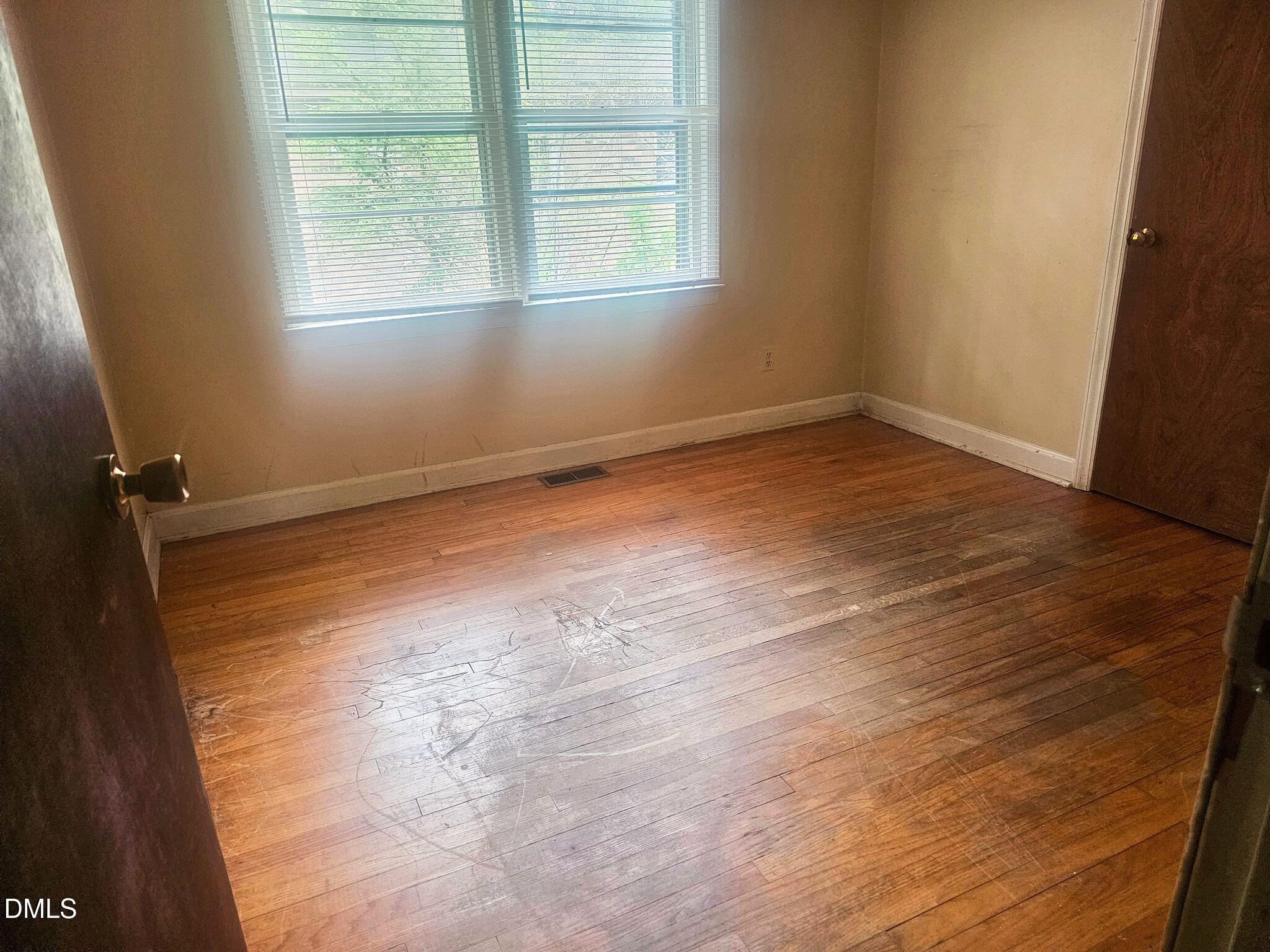 1649 Harper Street Rocky Mount, NC 27801 - Photo 15 of 34 an empty room with wooden floor and windows
