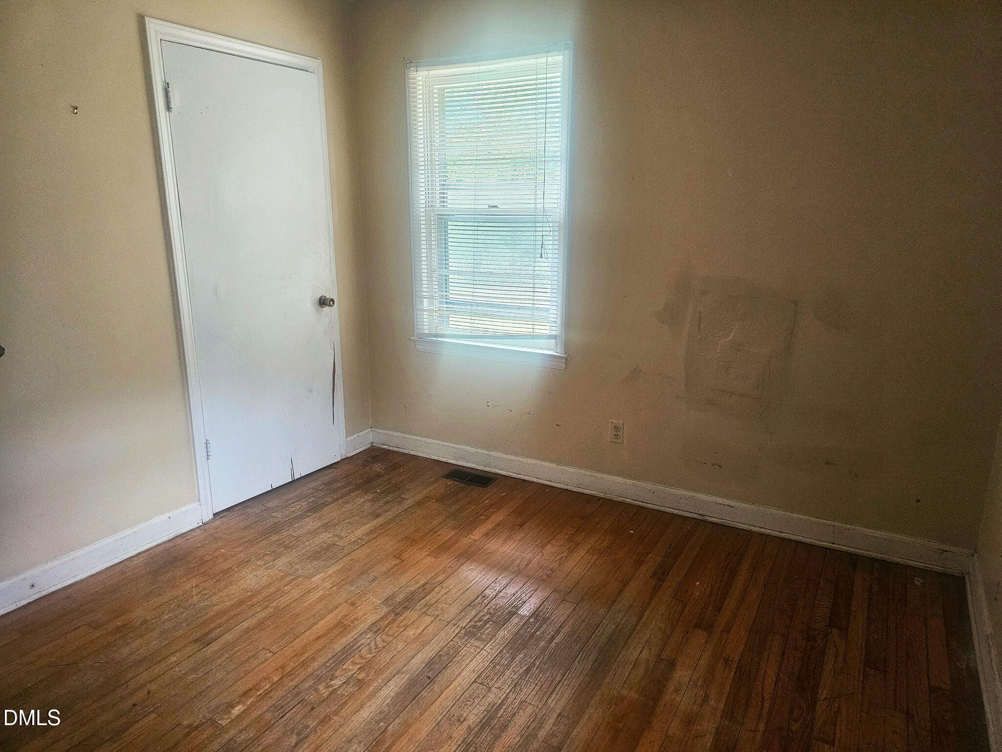 1649 Harper Street Rocky Mount, NC 27801 - Photo 20 of 34 a view of an empty room with wooden floor and a window