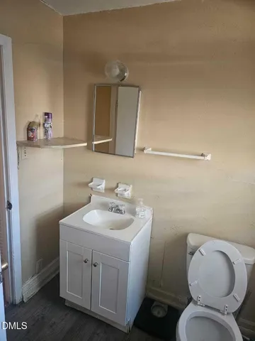 a bathroom with a toilet sink and mirror