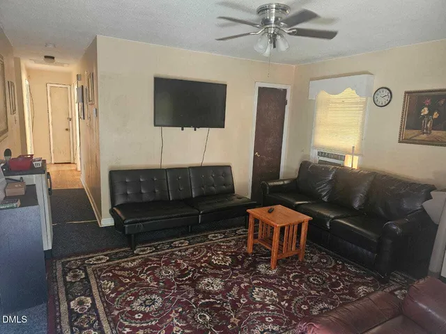 a living room with furniture and a rug