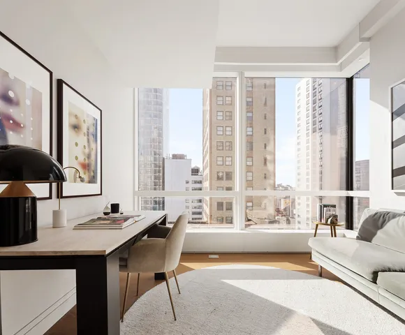 a living room with furniture and large windows