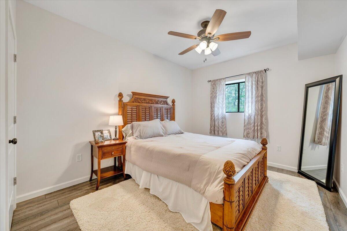 245 Timber Trail Lane Hardy, VA 24101 - Photo 30 of 38 a bedroom with a bed and a chandelier